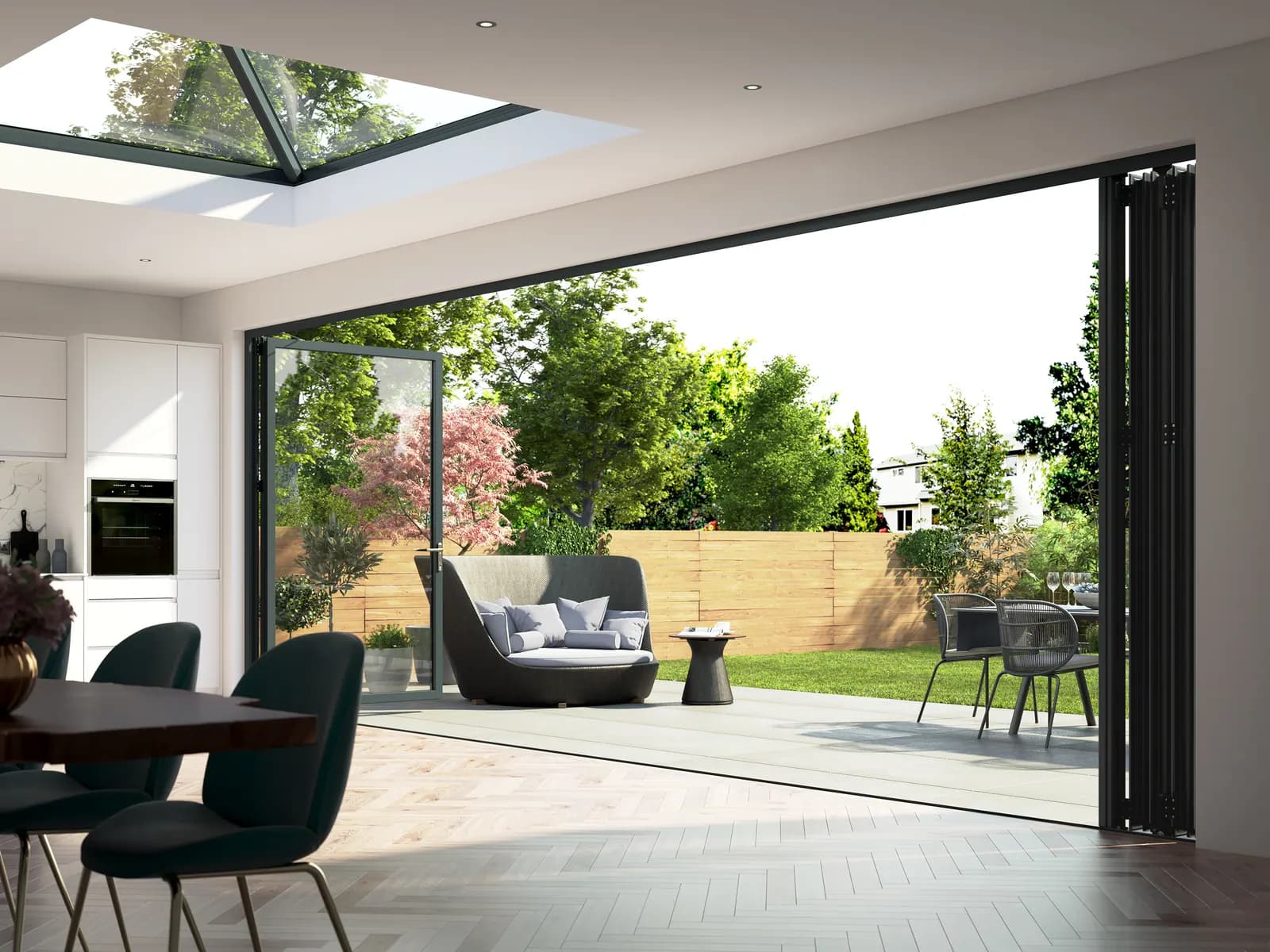 A five sash grey bifold folded fully open onto a garden, seen from the dining table