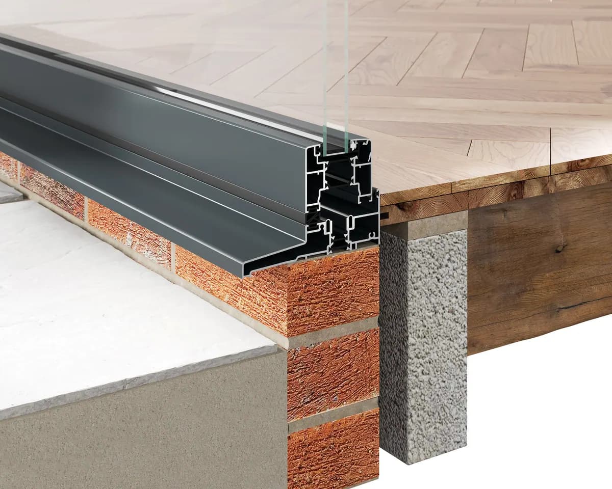 Cutaway through a bifold threshold sitting on a brick and block wall next to a timber floor