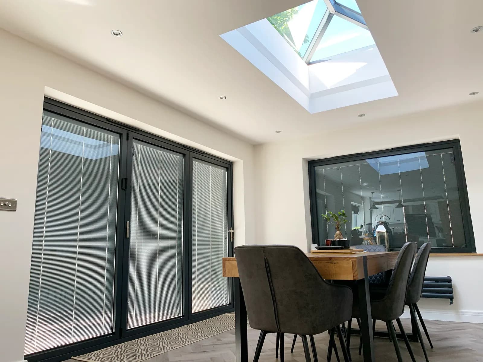 A finished room with a Korniche roof lantern and bifold doors
